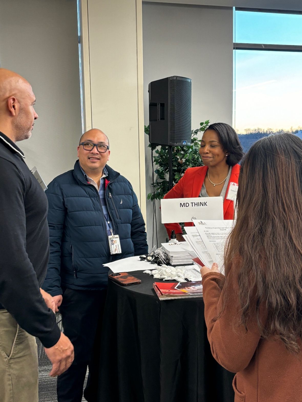 Multiple Maryland State Agency Representatives are having a conversation at an MIIC recruiting event.