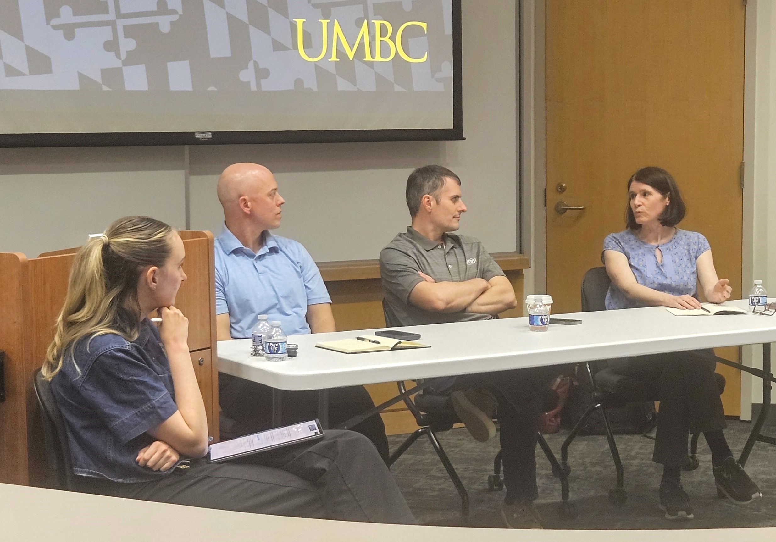 Parker (moderator) sits with three people who make up the expert panel, discussing responses to extreme events