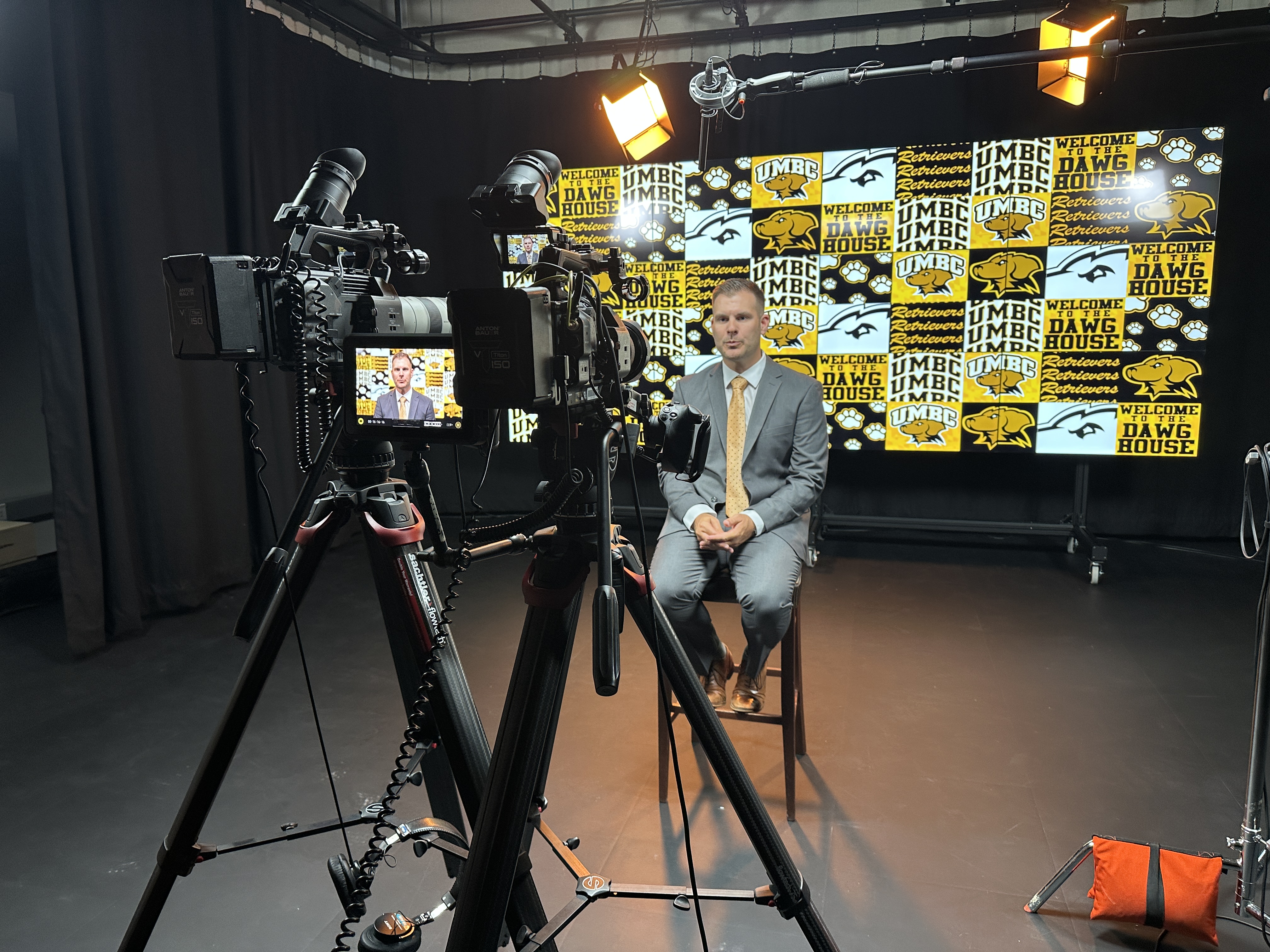 New UMBC Men's Lacrosse Head Coach James Purpura in front of the Studios new "video wall" that can be configured to project any backdrop for any video shoot.