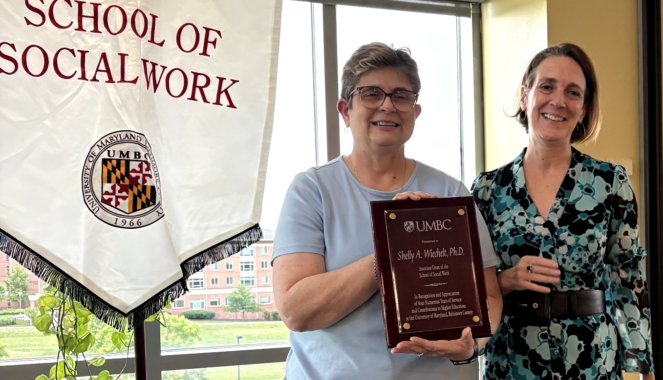 Shelly Wiechelt recieving a plaque honoring her service as associate dean from Vice Provost Ana Oskoz.
