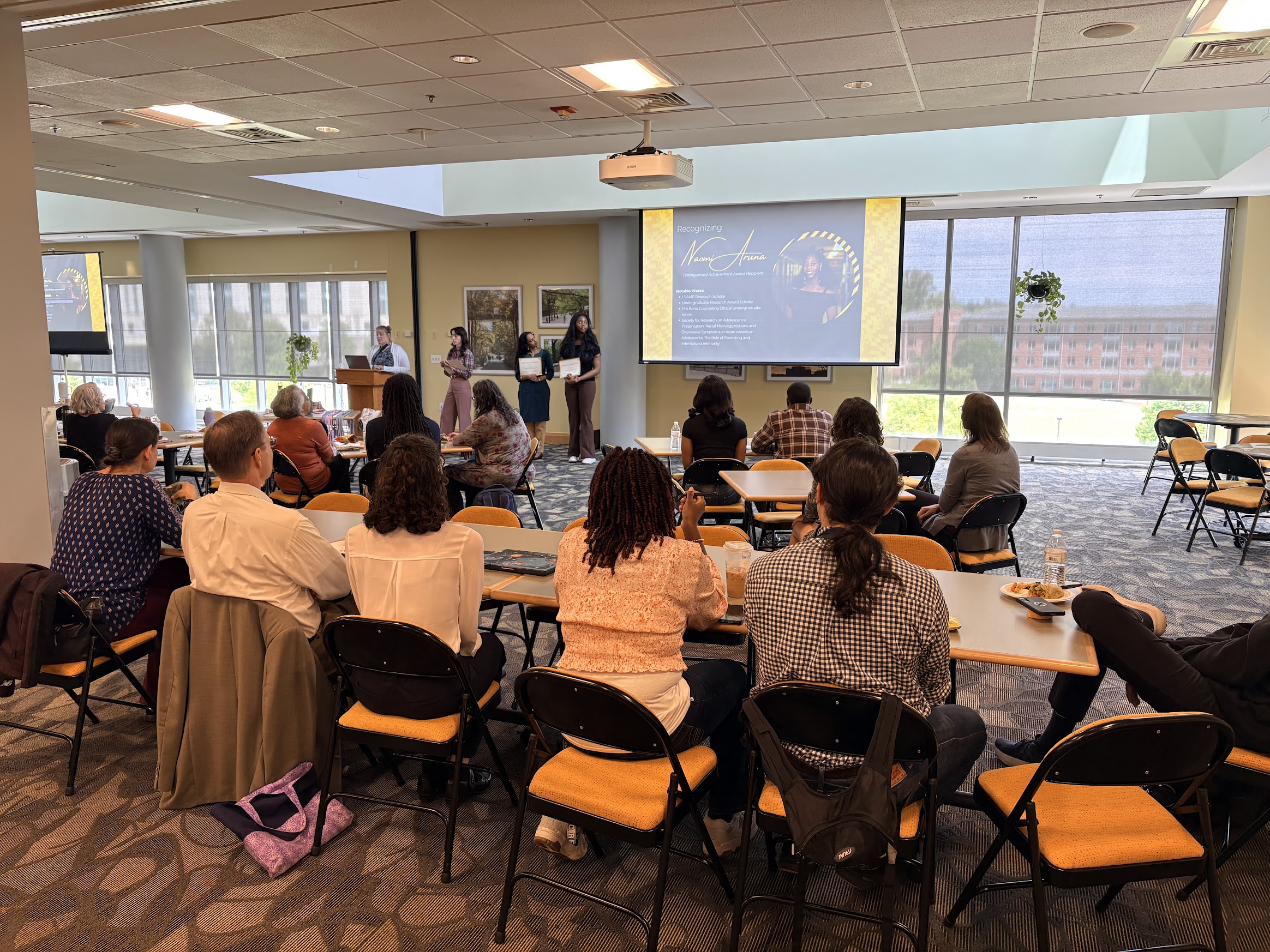 Attendees watch award ceremony in the Skylight Lounge
