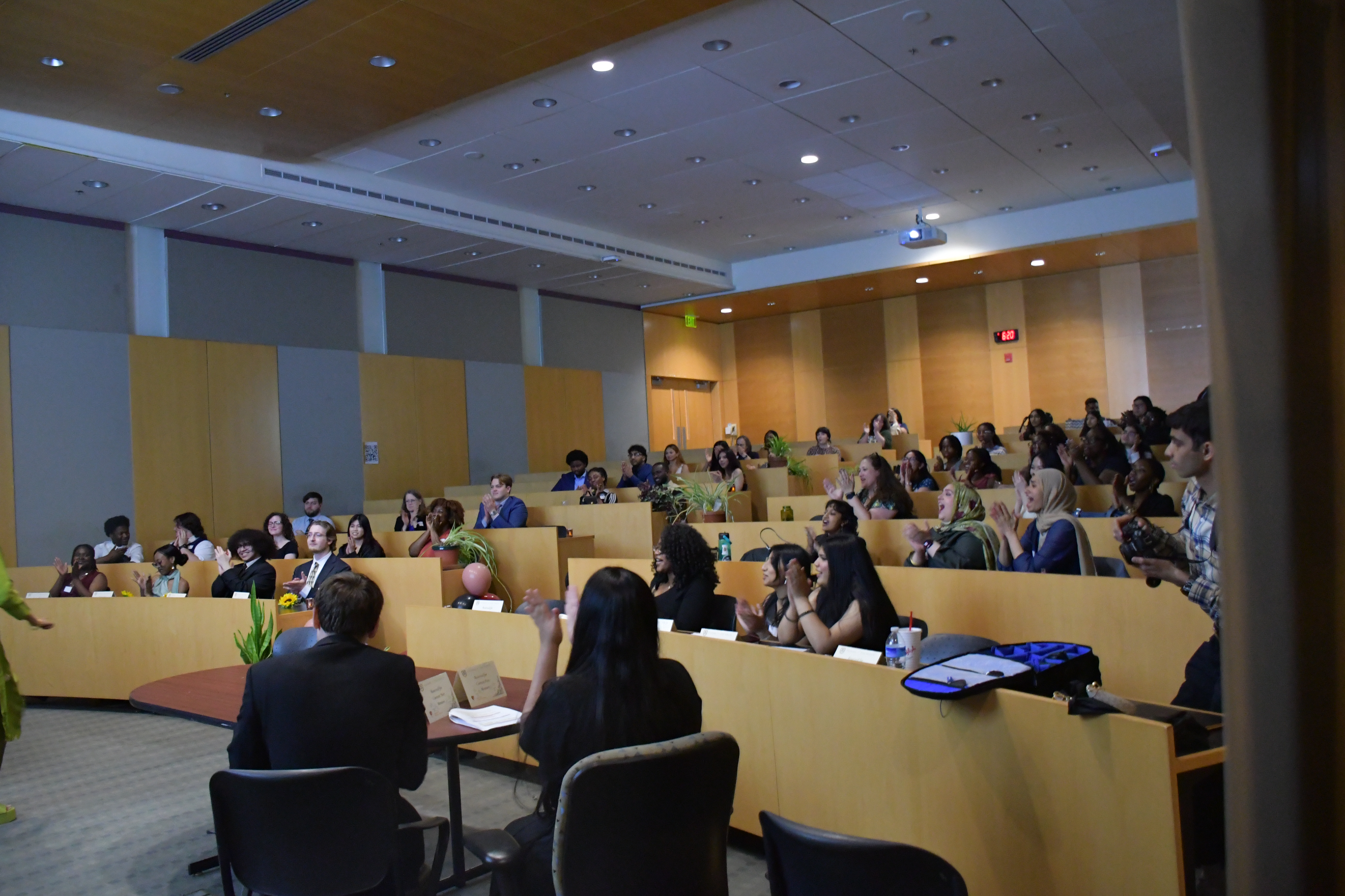 Shriver Living Learning Community students and guests in the Public Policy Building clapping during a celebration