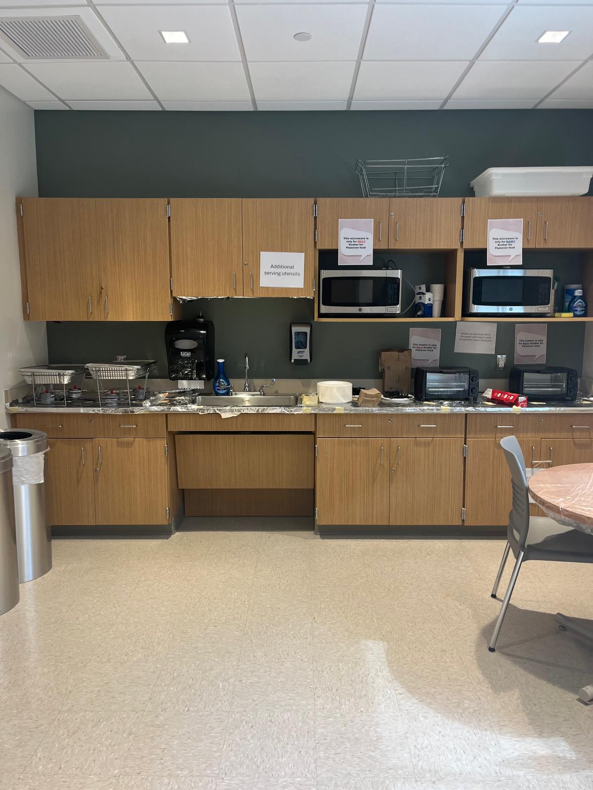 A photo of the Passover kitchenette space with the sternos, microwaves, and toaster ovens
