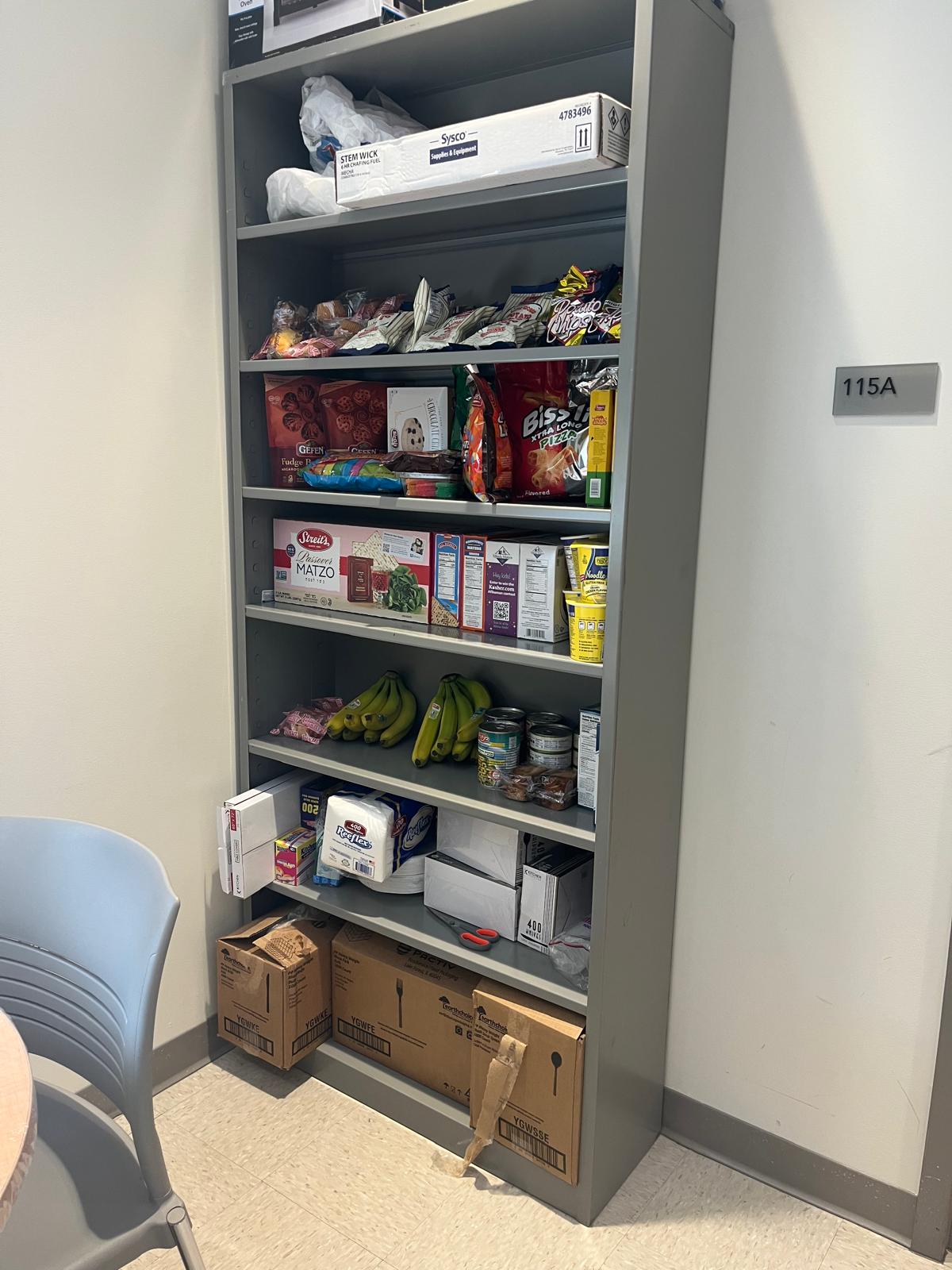 A photo of the Passover pantry self with the snacks and disposables.