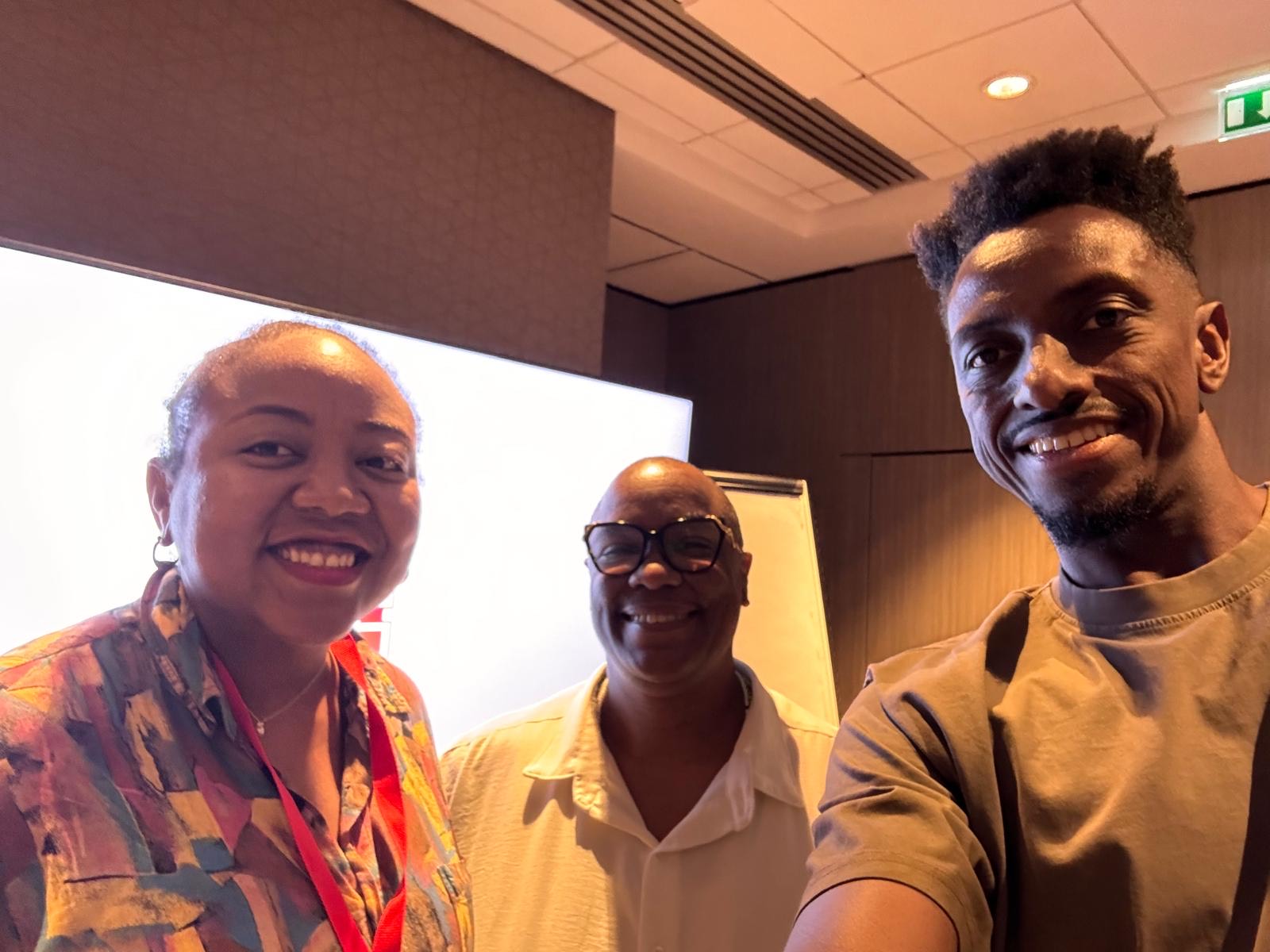 Three people smiling.