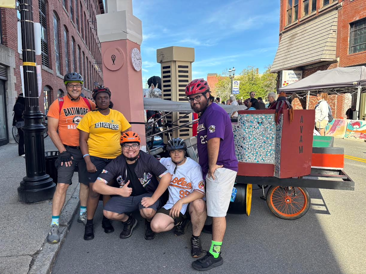 The Kinetic Sculpture Club standing in front of the Charm City Bromobile